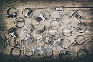 Old rusty curtain clips are placed on a wooden surface, top view, the effect of antiquity