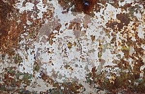 old rusty decaying metal surface with peeled and faded paint