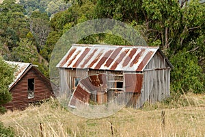 Old rusty derelict corrugated iron sheds in rural Tasmania. photo