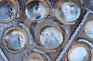 Old rusty dirty metal surface with round glass inserts background