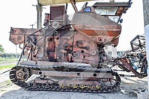 Old rusty disassembled combine harvester.