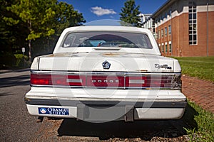 an old rusty Dodge dynasty car