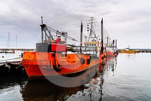 Old rusty dredge ship moored in the harbour of Sassnitz in Rugen Island