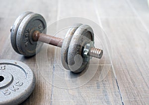 Old rusty dumbbells without use on a gray background