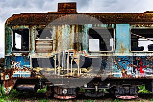 Old rusty electric multiple units abandoned on unused railway tracks