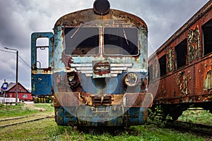 Old rusty electric train abandoned on unused siding