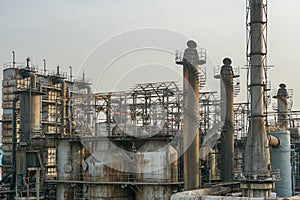 Old rusty factory metal structures with pipes.