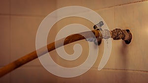 Old rusty faucet inside the house