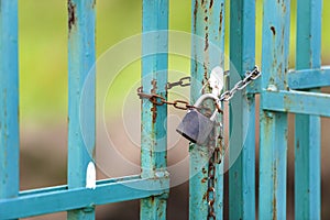Old rusty fence or gate with chained padlock