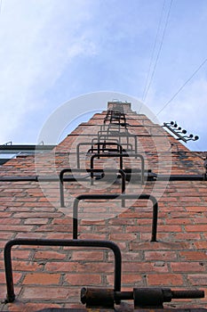 Old and rusty fire escape on the facade of a residential building.