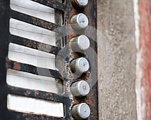 Old rusty flat apartment, abandoned building, house entry phone buttons, object detail, closeup, empty name tags, vacant lot