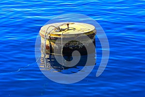 Old rusty floating sea buoy on the Red Sea against clear clear w
