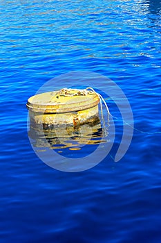 Old rusty floating sea buoy on the Red Sea against clear clear w