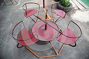 Old rusty four-seater round seesaw