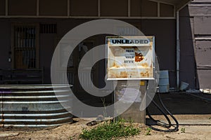 Old and rusty fuel pump in an abandoned gas station in the USA