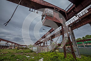 Old rusty gantry bridge crane in abandoned factory