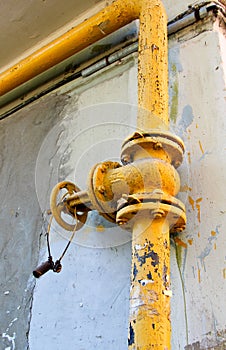 An old rusty gas control valve on the wall photo
