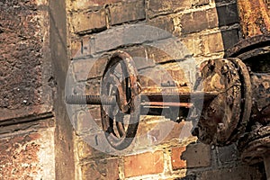 Old rusty gas control valve on the wall. The gas transmission system of Ukraine is failing