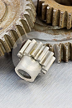 old rusty gear cogwheels on scratched metal industrial background