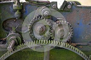 Old rusty gears. Gear wheels in agricultural equipment.