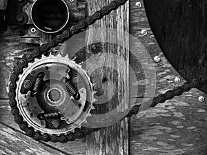 Old rusty gears mechanism arranged on wood background, black and white style. Mixed and match the background with gears.