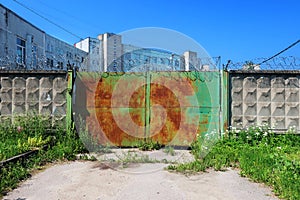 Old rusty green double-leaf iron gate