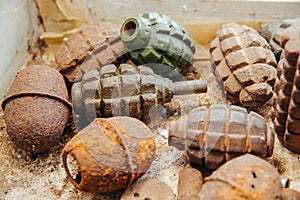 Old rusty grenades lying on the table