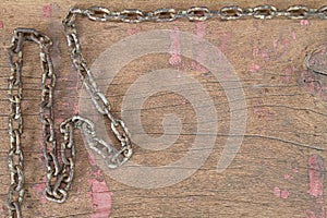 Old rusty grunge chain on vinatge grunge wooden background