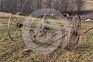 Old rusty hay tedder
