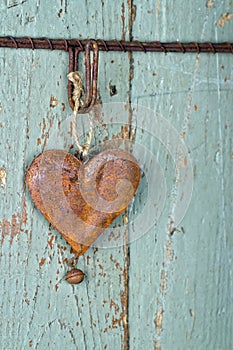 Old rusty heart on wooden background