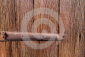 Old rusty hinge on wooden door, Old background for your design