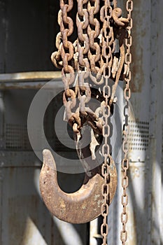 Old rusty hook and chain in abandoned coal mine.
