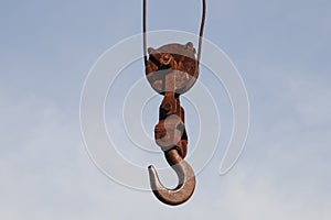 Old rusty hook of a hoisted crane in the port