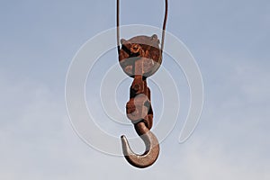 Old rusty hook of a hoisted crane in the port.