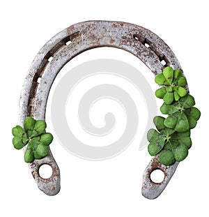 Old rusty horseshoe and four leaf clover