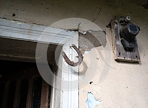 Old rusty horseshoe hanging on a door jamb