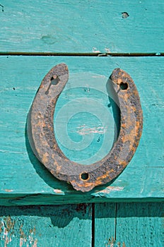 Old rusty horseshoe luck symbol on farm wall