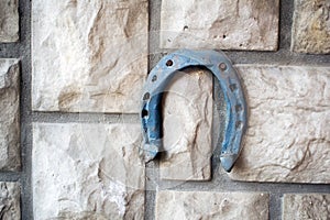 Old rusty horseshoe on a stone background