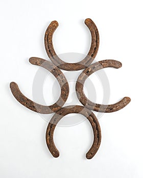 Old rusty horseshoes on white background