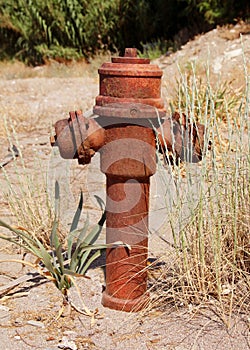 Old rusty hydrant on waste ground