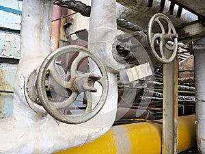 Old rusty industrial pipe valve for hot water at power plant