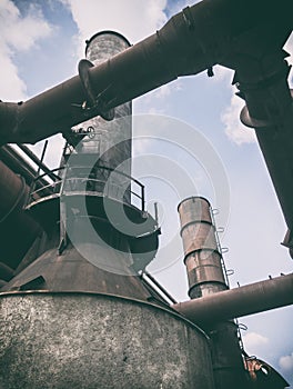 Old rusty industrial pipeline and smokestack