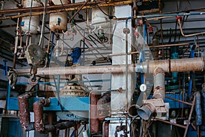 Old rusty Industrial tanks connected by pipes connected with valves