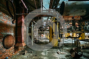 Old rusty Industrial tanks connected by pipes connected with valves in abandoned chemical factory