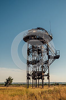 Old rusty iron abandoned watch tower in wastelands