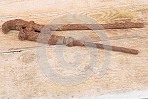 An old rusty iron adjustable spanner on wooden background