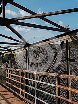 Old, rusty iron bridge for crossing over the rails