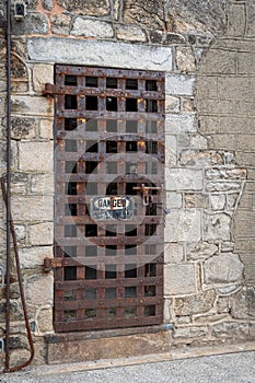 Old Rusty Iron Door in Stone Wall