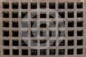 Old rusty iron street water sewer grate closeup top view