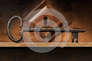 Old Rusty Key and a Wooden Keyhole on a Wood Shelf